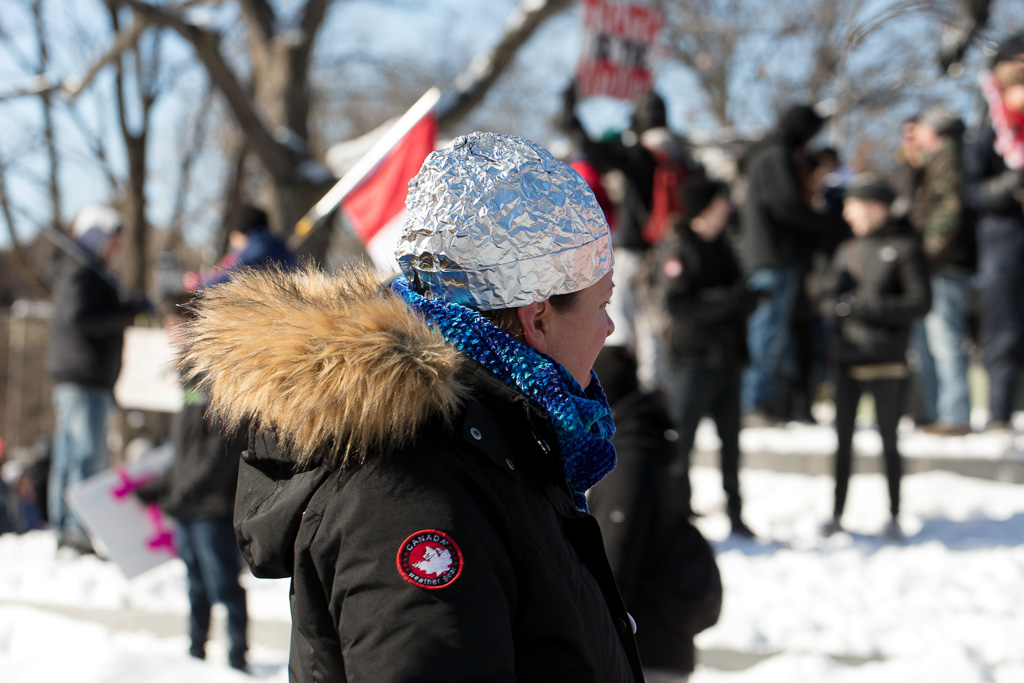 Protester wears tin foil hat in Queen's Park, Toronto