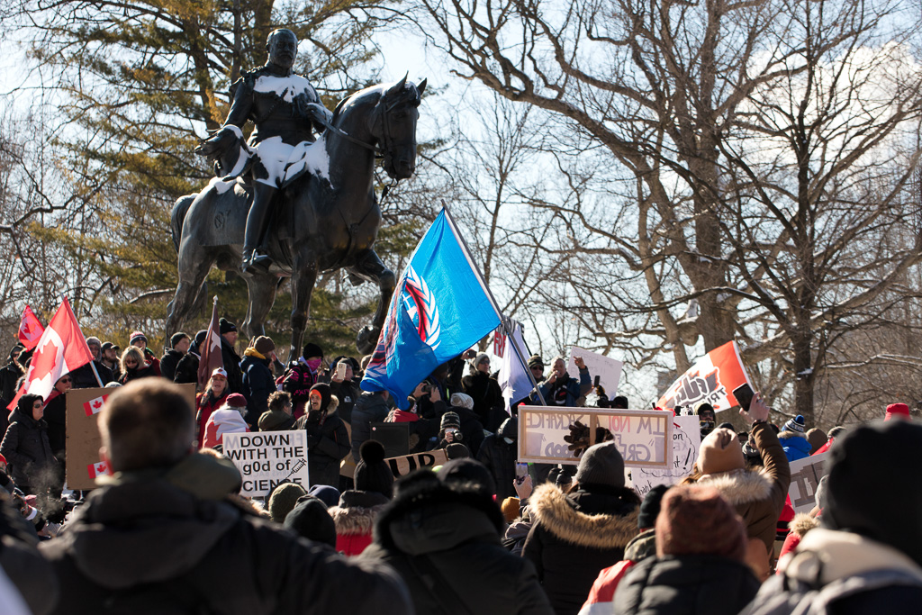 King Edward VII looks on as anti-vax protesters gather in Queen's Park, Toronto