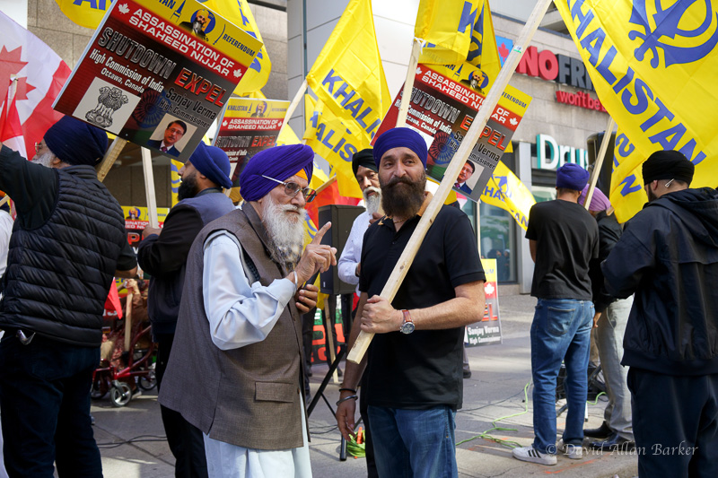 An elderly Sikh protester points to something outside the Indian Consulate in Toronto.