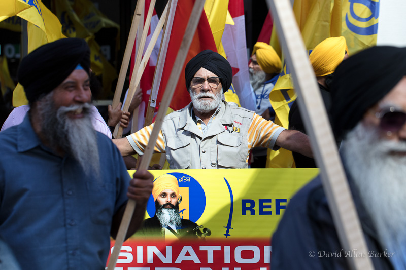Sikh protester holds sign in front of the Indian Consulate in Toronto.